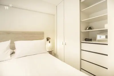 a bedroom with a white bed and a closet at Connect by Wynwood House in Lima