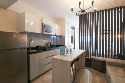 a kitchen with a counter and a sink and a refrigerator at Connect by Wynwood House in Lima