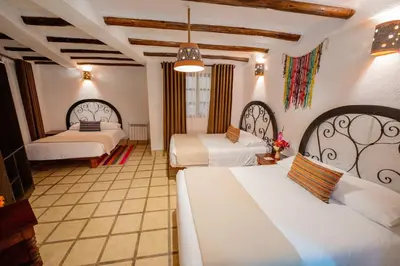 a hotel room with two beds in a room at Vilas Insight Hotel Machupicchu in Machu Picchu