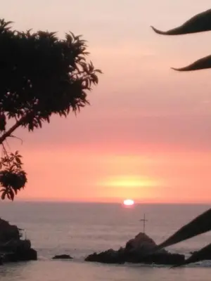 a sunset over the ocean with the sun in the sky at La Casa Maruja Habitación doble P in San Bartolo