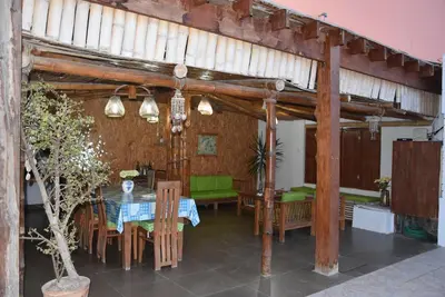a dining room with a table and chairs at La Casa Maruja Habitación doble P in San Bartolo