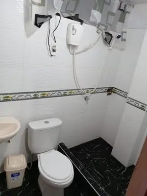 a bathroom with a white toilet and a sink at La Esquina de Doña Julia in Lima