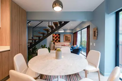 a dining room with a white table and chairs at ✶ Pisac Penthouse ✶ 3-stories LUXURY Rooftop Pool in Lima