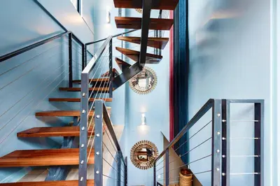 a spiral staircase in a home with blue walls at ✶ Pisac Penthouse ✶ 3-stories LUXURY Rooftop Pool in Lima
