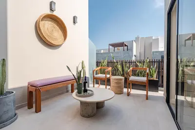 a balcony with a bench and chairs and a table at ✶ Pisac Penthouse ✶ 3-stories LUXURY Rooftop Pool in Lima