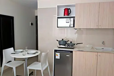 a small kitchen with a table and a counter top at Residencial Suiza in Lima