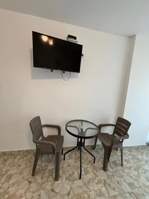 a room with a table and two chairs and a tv at El Gamonal - Paracas in Paracas