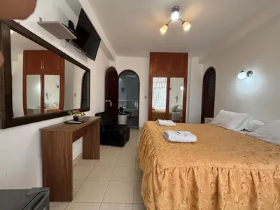 a bedroom with a large bed and a mirror at Mar Azul in Paracas