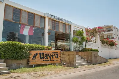 a welcome sign in front of a building at Hotel Emancipador in Paracas