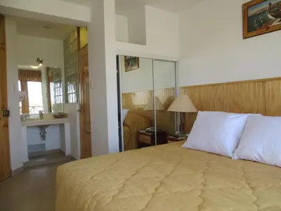 a bedroom with a large bed in a room at Hotel Los Flamencos in Paracas