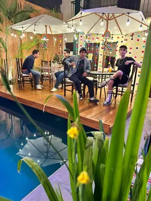a group of men sitting on a wooden table at Llaqta Wasi in Lima