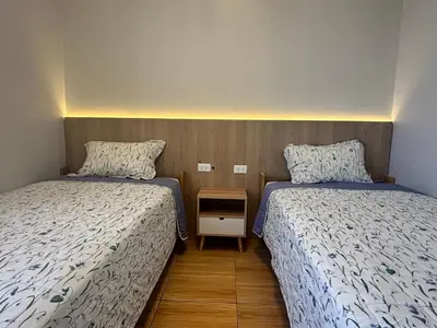 two beds sitting next to each other in a room at Qurpawasi in Lima