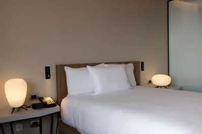 a bedroom with a bed with two lamps and a phone at Hilton Garden Inn Lima Miraflores in Lima