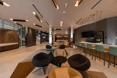a lobby with chairs and a bar in the background at Hilton Garden Inn Lima Miraflores in Lima