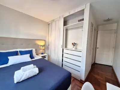 a bedroom with a blue bed and a window at Habitación Privada en departamento Compartido in Lima