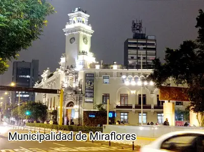 a large white building with a clock tower at night at Habitación Privada en departamento Compartido in Lima