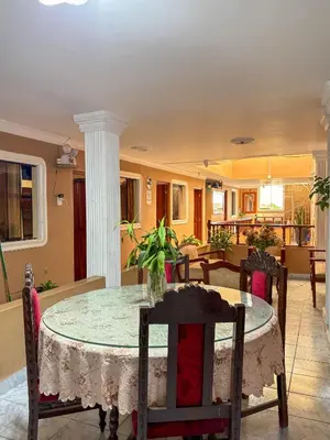 a dining room with a table and chairs at Hospedaje Anais in Pisco