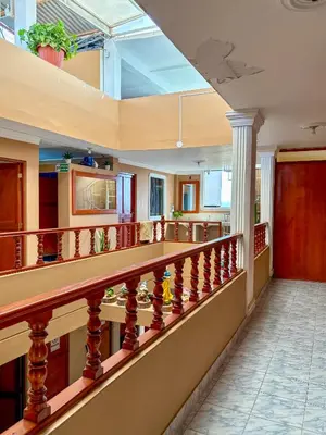a lobby with a staircase with a skylight at Hospedaje Anais in Pisco