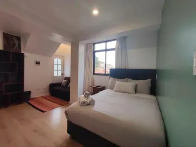 a bedroom with a large bed and a window at Casa Agustina in Cusco