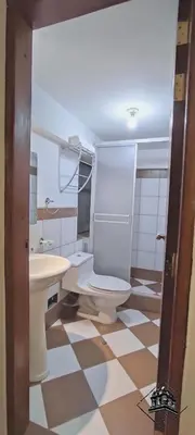 a bathroom with a toilet and a sink at Elsa Wasi Cusco in Cusco