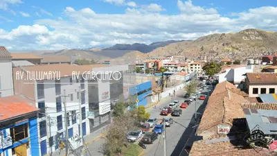 an aerial view of a city with cars on a street at Elsa Wasi Cusco in Cusco