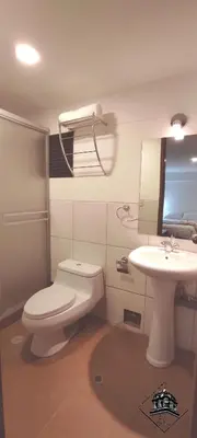 a bathroom with a toilet and a sink and a mirror at Elsa Wasi Cusco in Cusco