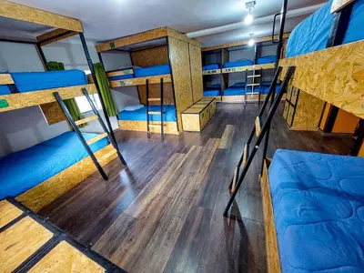 a room with several bunk beds in a bus at Ukukus Hostel in Cusco