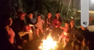 a group of people sitting around a fire at Illa Wasi Sacred Valley in Urubamba