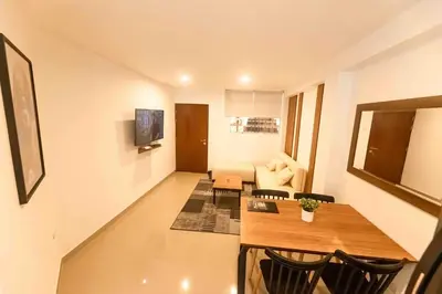 a living room with a table and a couch at Moderno Departamento en Barranca in Barranca