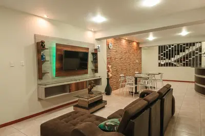 a living room with a couch and a television at Hotel Residencial San Isidro in Hualmay