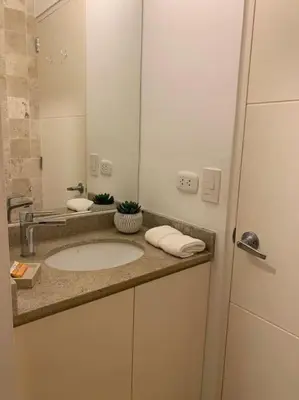 a bathroom with a sink and a mirror at Suite en San Isidro-Frente al Supermercado Vivanda in Lima