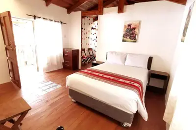 a bedroom with a large bed in a room at APARMENT SAMANA HOUSE OLLANTAYTAMBO in Ollantaytambo