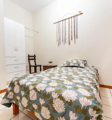 a bedroom with a bed with a quilt on it at JUMANA in Nazca