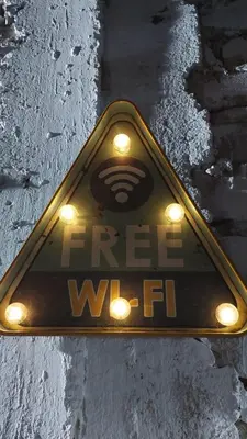 a sign that says free wifi on a street at JUMANA in Nazca