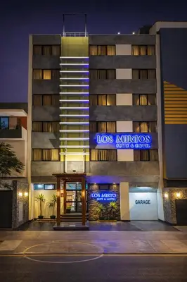a building with a sign on the front of it at Los Mirtos suite & Hotel in Lima