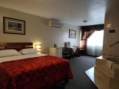 a hotel room with a bed and a desk at Los Mirtos suite & Hotel in Lima