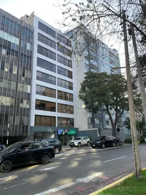 a parking lot with cars parked in front of a building at Miraflores Center - Larcomar, Parque Kennedy, Malecón in Lima