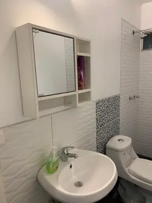 a white bathroom with a sink and a toilet at Miraflores Center - Larcomar, Parque Kennedy, Malecón in Lima
