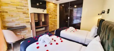 a hotel room with two beds with hearts on them at Hotel Raices Machupicchu in Machu Picchu