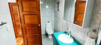a bathroom with a toilet and a sink and a mirror at 7th Wonder Apart Hotel Cusco in Cusco