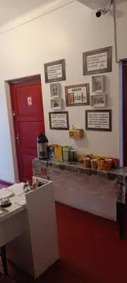 a kitchen with a counter with a red door and a counter sidx sidx at SK Hostal in Cusco