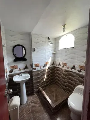 a bathroom with a toilet and a sink at Hostal Sol de Chosica in Chosica