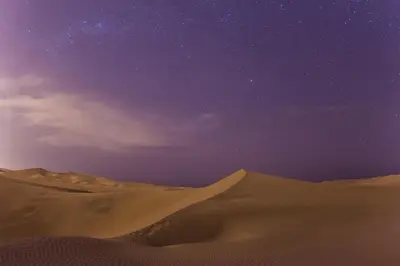 a starry night in the desert with sand dunes at Hosteria Suiza in Ica