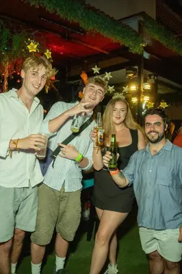a group of people posing for a picture at a party at Wild Rover Huacachina in Ica