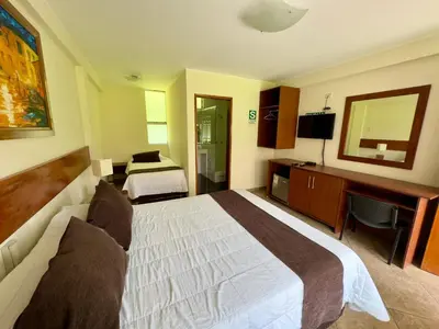 a hotel room with a bed and a desk at Rio Lindo Ecolodge in Lunahuaná