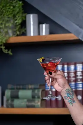 a person holding a martini glass in their hand at Casa Tunki in Cusco