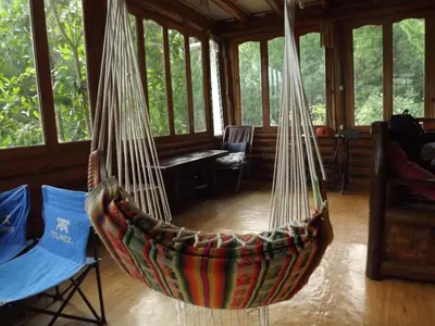 a room with a hammock in a house at La Casita de Oxapampa in Oxapampa