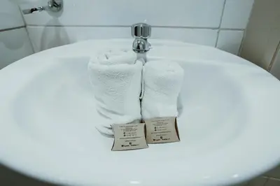 a towel sitting on top of a toilet in a bathroom at Cochito Cusco in Cusco