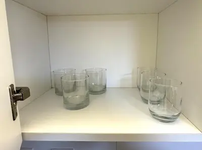 four empty glasses sitting on a shelf at Loft Central Miraflores in Lima