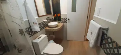 a small bathroom with a toilet and a sink at Hotel Garden House Huerta in Limatambo
